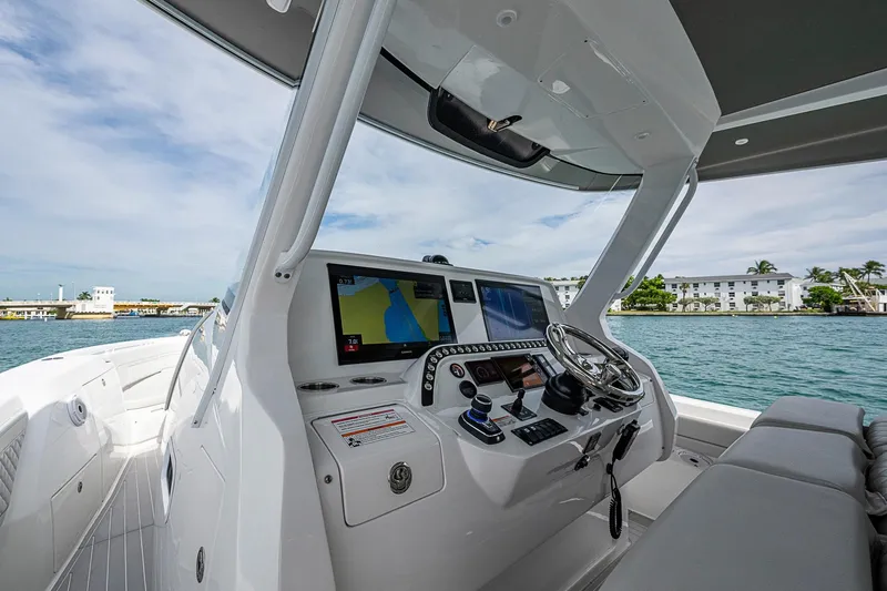 Slide: The Image of 2023 Intrepid 427 Nomad SE boat cockpit with advanced navigation system on a sunny day. - 43