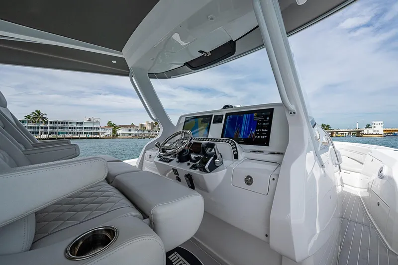 Slide: The Image of 2023 Intrepid 427 Nomad SE boat interior with modern dashboard and luxurious seating. - 49