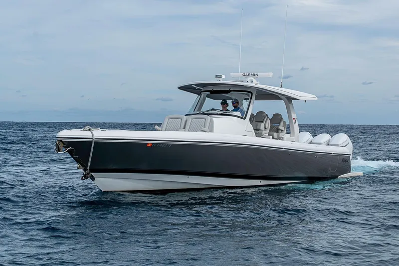 Slide: The Image of 2023 Intrepid 427 Nomad SE cruising on open water under a cloudy sky. - 53