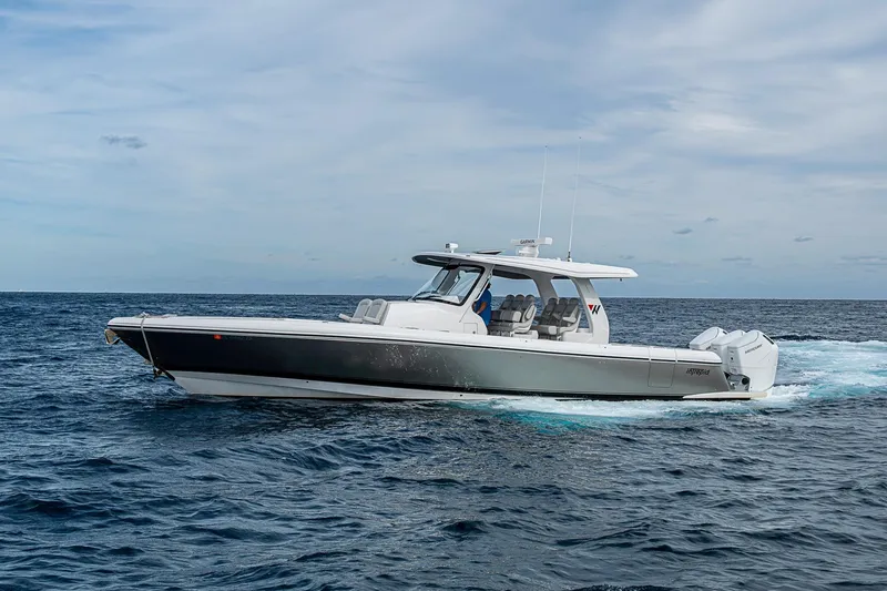 Slide: The Image of 2023 Intrepid 427 Nomad SE cruising on open ocean under cloudy sky. - 56