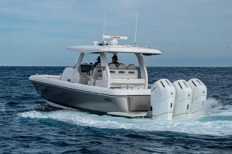 Slide: The Image of 2023 Intrepid 427 Nomad SE boat cruising on open ocean waters. - 60