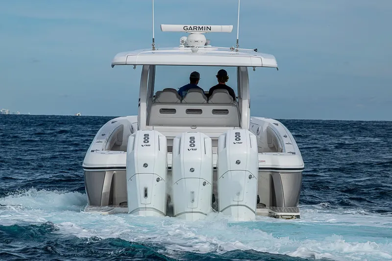 Slide: The Image of 2023 Intrepid 427 Nomad SE boat with triple 600 V12 engines cruising on open water. - 61