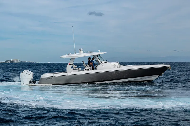 Slide: The Image of 2023 Intrepid 427 Nomad SE boat cruising on open water. - 64