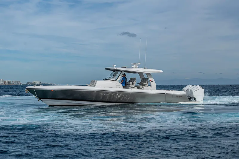 Slide: The Image of 2023 Intrepid 427 Nomad SE cruising on open water under a clear sky. - 69