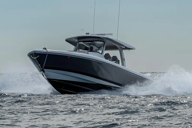 Slide: The Image of 2023 Intrepid 427 Nomad SE boat cruising on open water, creating splashes. - 75