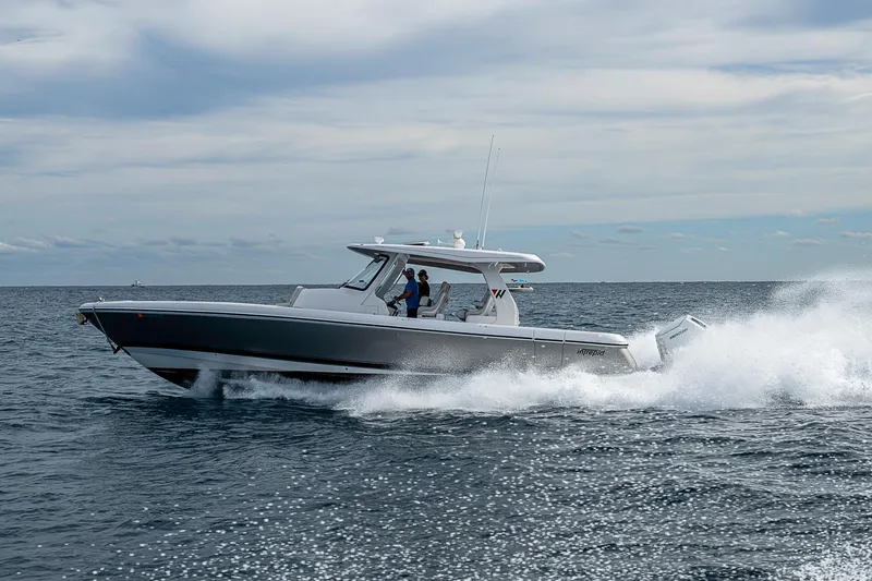 Slide: The Image of 2023 Intrepid 427 Nomad SE cruising on open water under a cloudy sky. - 79