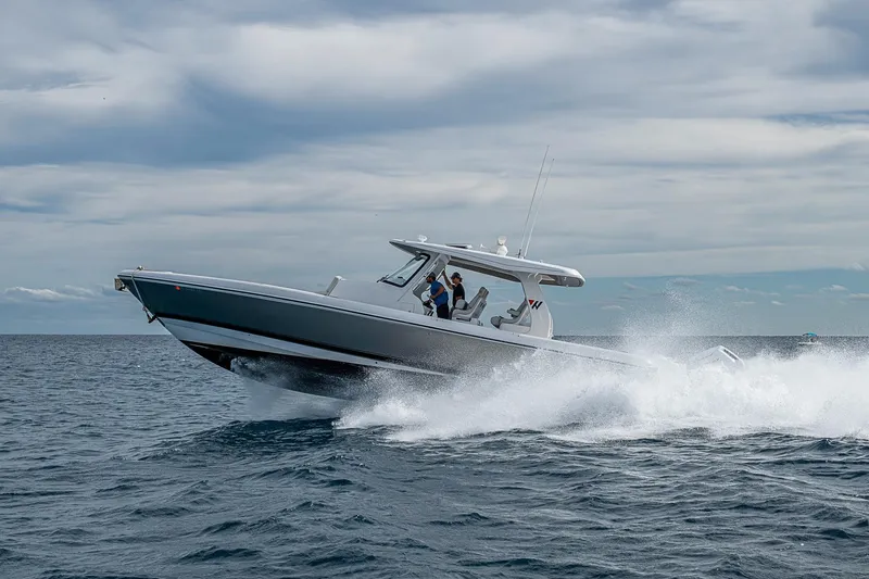 Slide: The Image of 2023 Intrepid 427 Nomad SE cruising on open water under cloudy skies. - 80