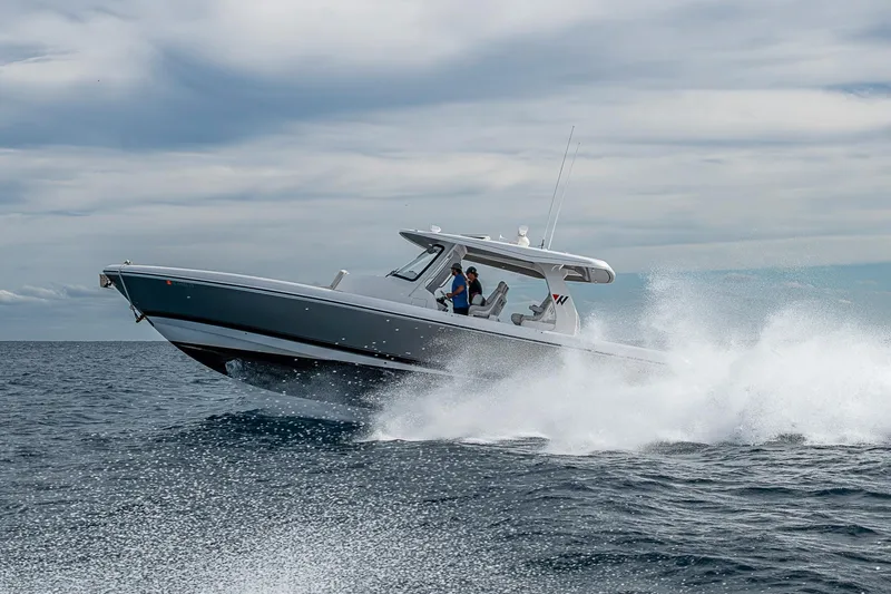 Slide: The Image of 2023 Intrepid 427 Nomad SE cruising on open ocean with splashing waves. - 82