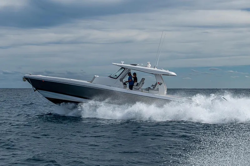 Slide: The Image of 2023 Intrepid 427 Nomad SE cruising on open water under cloudy skies. - 83