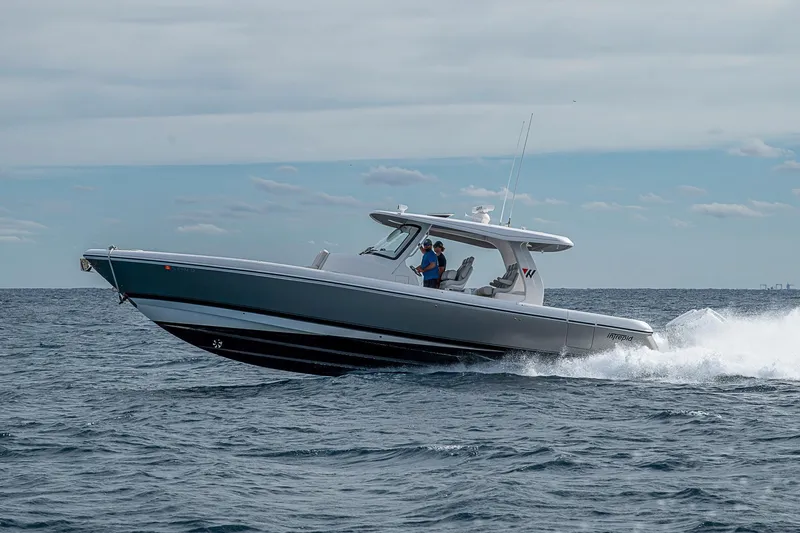 Slide: The Image of 2023 Intrepid 427 Nomad SE cruising on open water under a cloudy sky. - 87