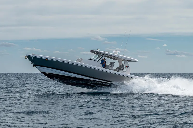 Slide: The Image of 2023 Intrepid 427 Nomad SE cruising on open water, showcasing sleek design and performance. - 88