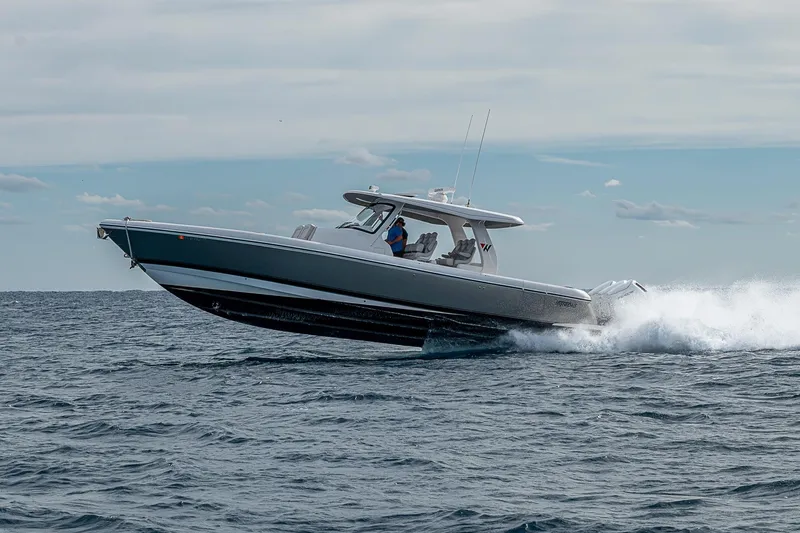 Slide: The Image of 2023 Intrepid 427 Nomad SE cruising on open water, showcasing sleek design and performance. - 89