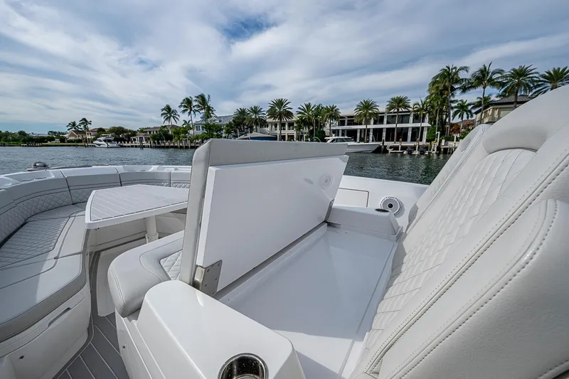 Slide: The Image of 2023 Intrepid 427 Nomad SE boat interior with luxurious seating and scenic waterfront view. - 9