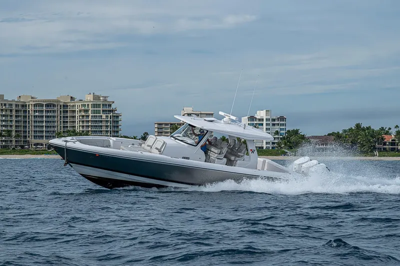 Slide: The Image of 2023 Intrepid 427 Nomad SE cruising on water near coastal buildings. - 90