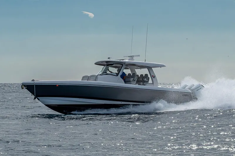 Slide: The Image of 2023 Intrepid 427 Nomad SE cruising on open water, showcasing sleek design and performance. - 95