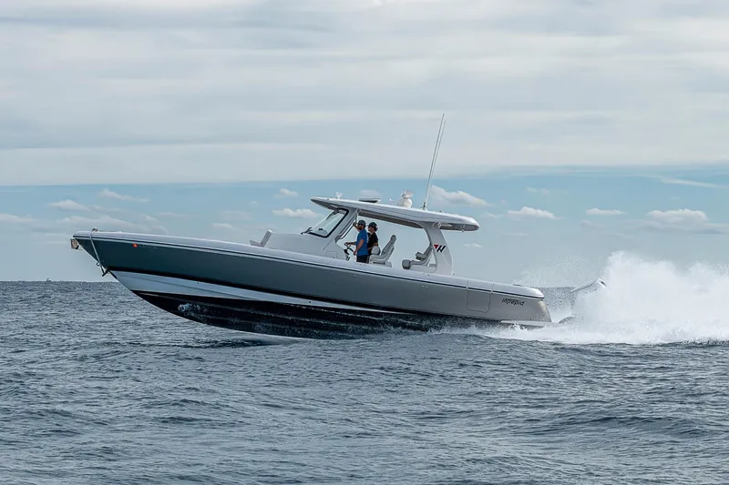 Slide: The Image of 2023 Intrepid 427 Nomad SE cruising on open water under cloudy skies. - 96