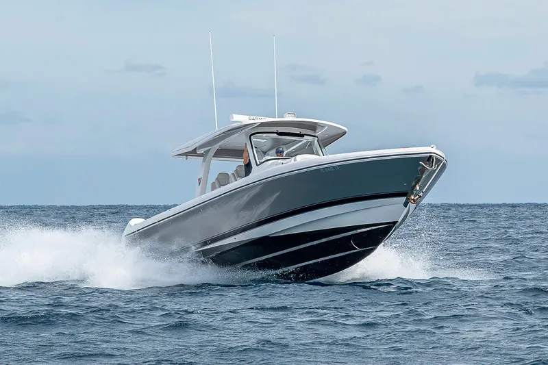 Slide: The Image of 2023 Intrepid 427 Nomad SE cruising on open water, showcasing sleek design and performance. - 99