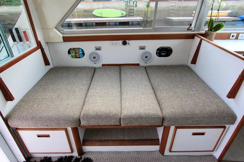 Slide: The Image of port side dinette converts to 6'2" bunk. Custom Interior by Crystaliner Corp. - 32