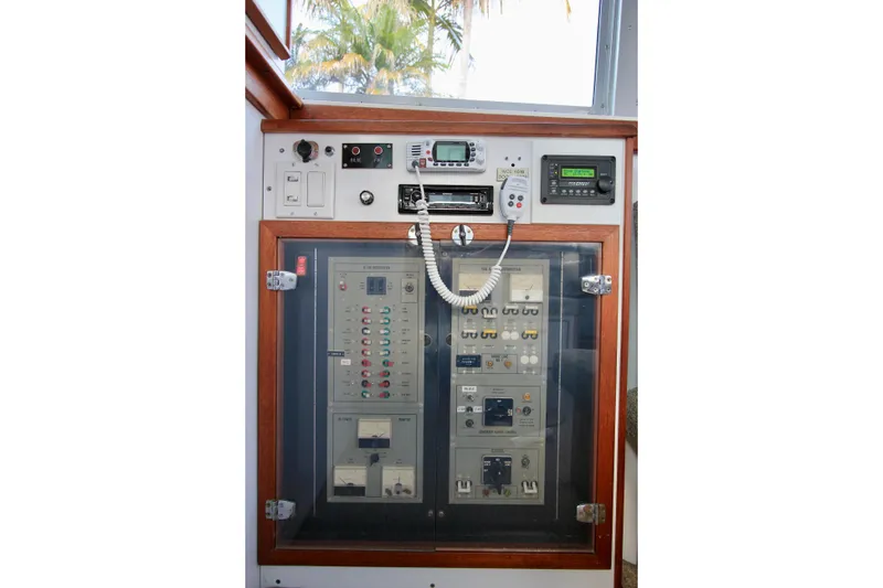 Slide: The Image of Main electrical panel with generator controls, stereo, inverter, and VHF radio. - 38