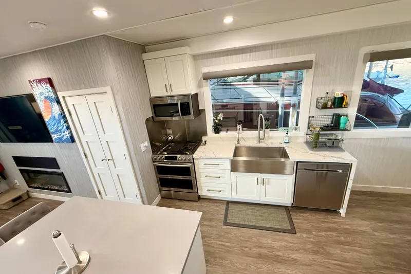 Slide: The Image of Modern kitchen interior on 2021 BRAVADA YACHTS Atlas V Series 8018, featuring stainless steel appliances. - 11
