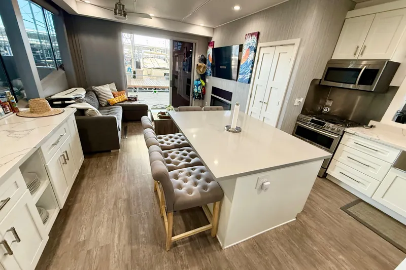 Slide: The Image of Luxurious interior of 2021 BRAVADA YACHTS Atlas V Series 8018 with modern kitchen and cozy seating area. - 12