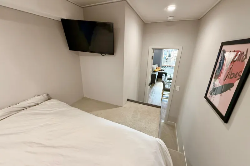 Slide: The Image of Bedroom interior of 2021 BRAVADA YACHTS Atlas V Series 8018 with TV and modern decor. - 16