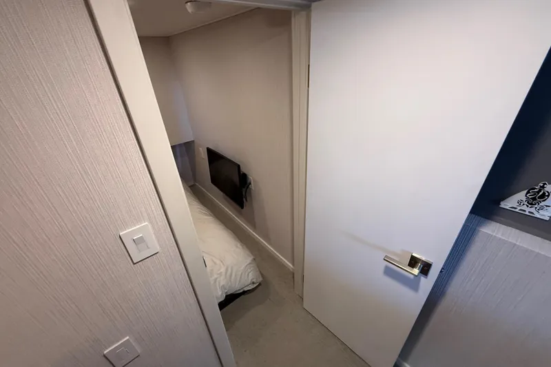 Slide: The Image of Interior of 2021 BRAVADA YACHTS Atlas V Series 8018, featuring a cozy bedroom with TV. - 19