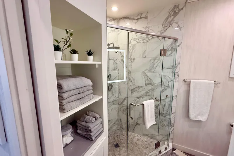 Slide: The Image of Luxurious bathroom in 2021 Bravada Yachts Atlas V Series 8018 with marble shower and elegant shelving. - 23