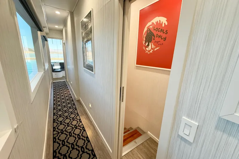Slide: The Image of Hallway in 2021 BRAVADA YACHTS Atlas V Series 8018, featuring modern decor and artwork. - 25