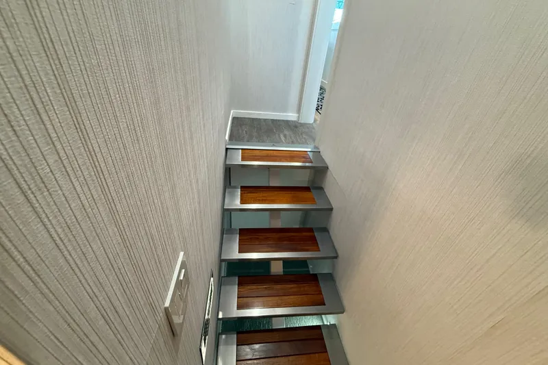 Slide: The Image of Staircase inside 2021 BRAVADA YACHTS Atlas V Series 8018, featuring wood and metal steps. - 28