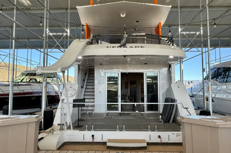 Slide: The Image of 2021 Bravada Yachts Atlas V Series 8018 docked, featuring a slide and spacious deck. - 3