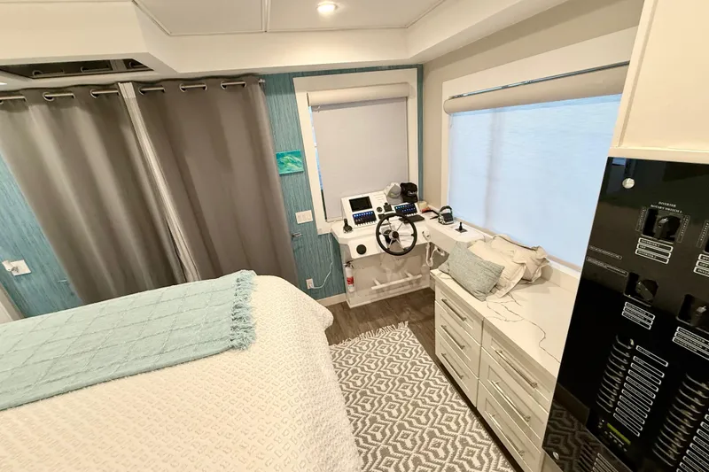 Slide: The Image of Interior of 2021 BRAVADA YACHTS Atlas V Series 8018, featuring helm and cozy bedroom. - 32