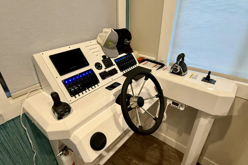 Slide: The Image of Control panel of 2021 BRAVADA YACHTS Atlas V Series 8018 with steering wheel and navigation equipment. - 34