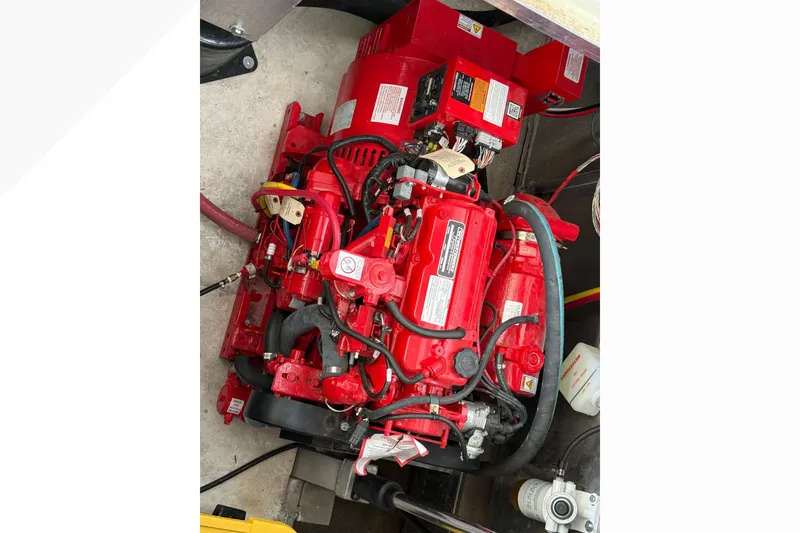 Slide: The Image of Engine compartment of 2021 BRAVADA YACHTS Atlas V Series 8018, featuring a red marine engine. - 63