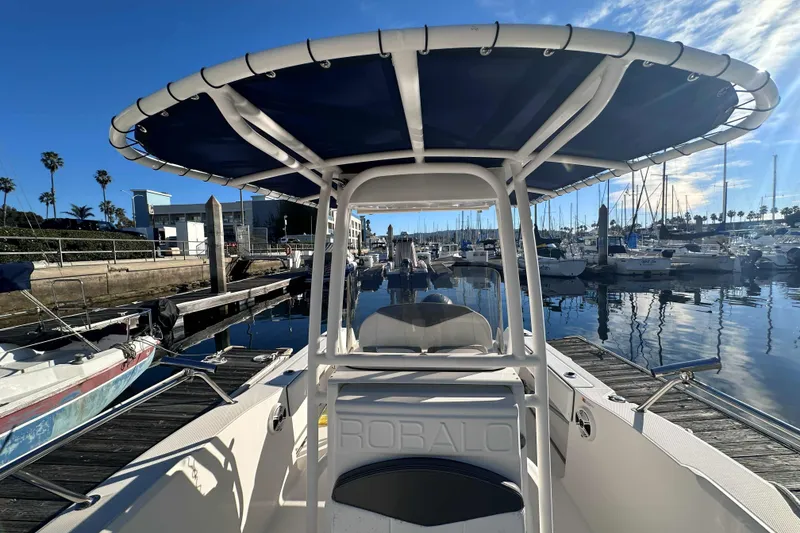 Slide: The Image of 2018 Robalo R200 Center Console boat docked at marina under clear blue sky. - 10