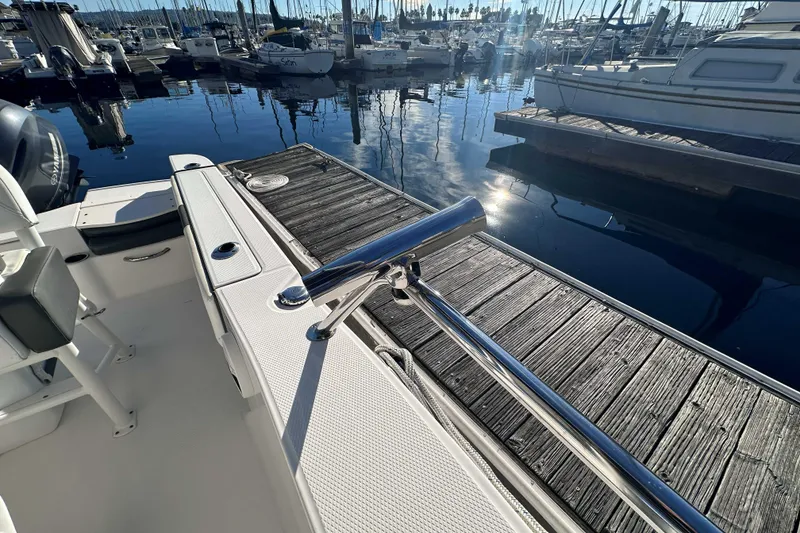 Slide: The Image of 2018 Robalo R200 Center Console boat docked at marina, sunny day reflection. - 11