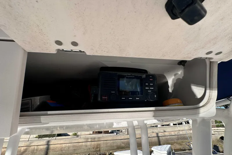 Slide: The Image of 2018 Robalo R200 Center Console storage with Garmin device inside. - 13