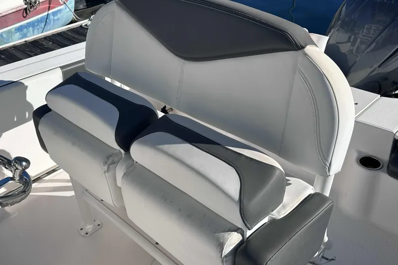 Slide: The Image of 2018 Robalo R200 Center Console boat seating with white and gray upholstery. - 7