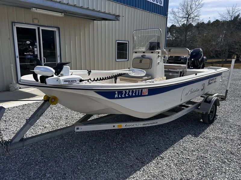 Slide: The Image of 2024 Carolina Skiff JVX18CC boat on trailer outside building. - 2