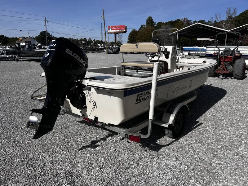 Slide: The Image of 2024 Carolina Skiff JVX18CC boat with Suzuki motor on trailer. - 4