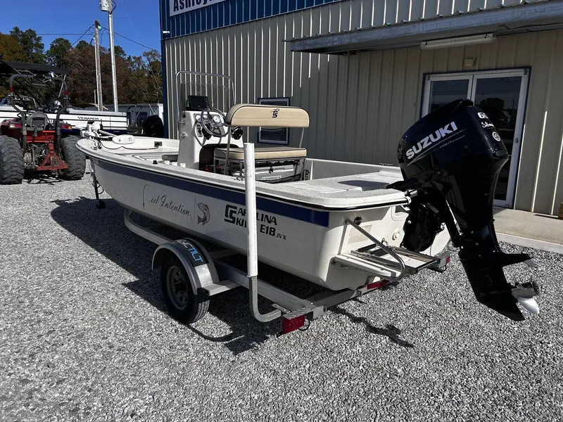 Slide: The Image of 2024 Carolina Skiff JVX18CC boat with Suzuki motor on trailer. - 5