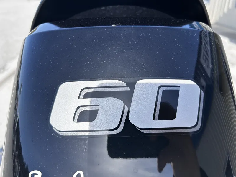 Slide: The Image of Close-up of a 60 HP engine, Carolina Skiff JVX18CC 2024. - 7