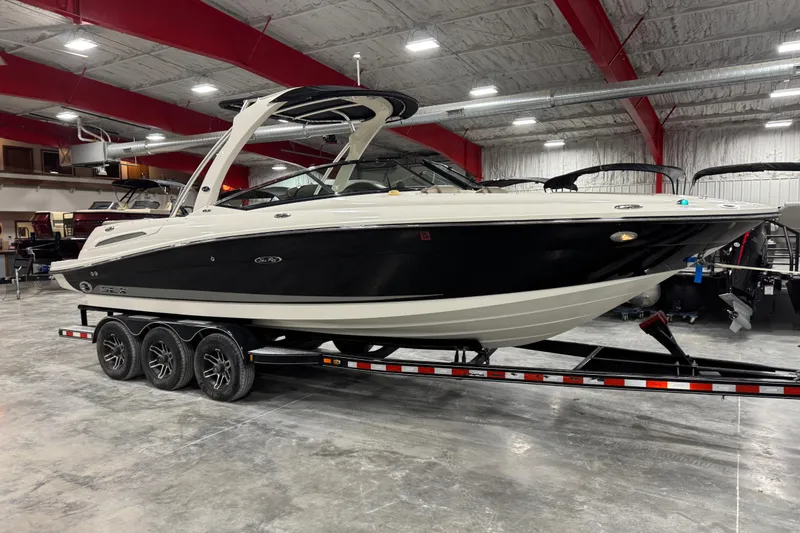 The Image of 2011 Sea Ray SLX 250 boat on trailer in indoor showroom. - 1
