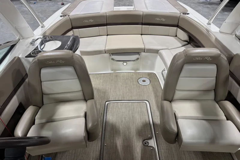 Slide: The Image of Interior of a 2011 Sea Ray SLX 250 boat with beige seating and carpet. - 10