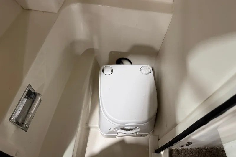 Slide: The Image of Compact marine toilet in 2011 Sea Ray SLX 250 boat interior. - 11