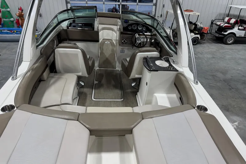 Slide: The Image of Interior of a 2011 Sea Ray SLX 250 boat with seating and helm. - 12
