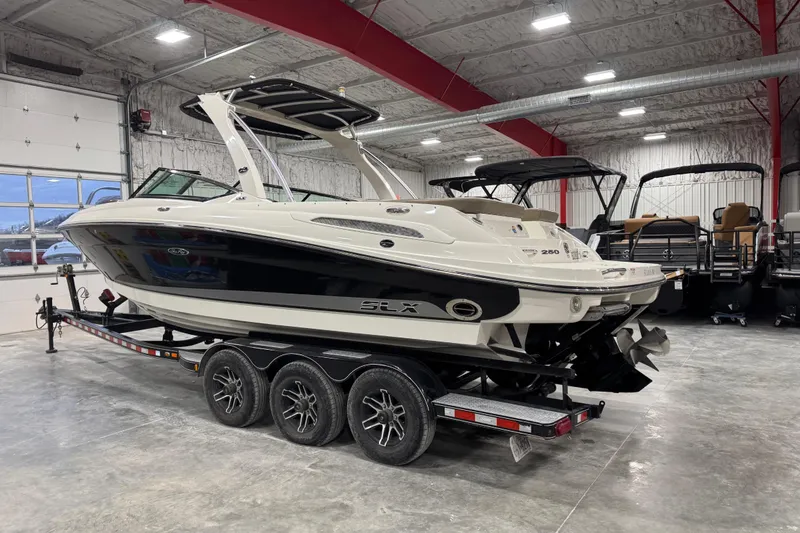Slide: The Image of 2011 Sea Ray SLX 250 boat on trailer in indoor showroom. - 3