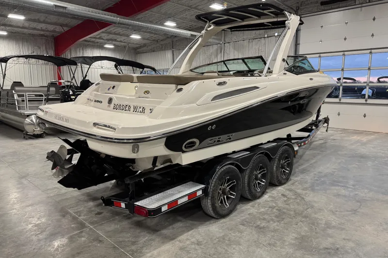 Slide: The Image of 2011 Sea Ray SLX 250 boat on trailer in indoor storage facility. - 4