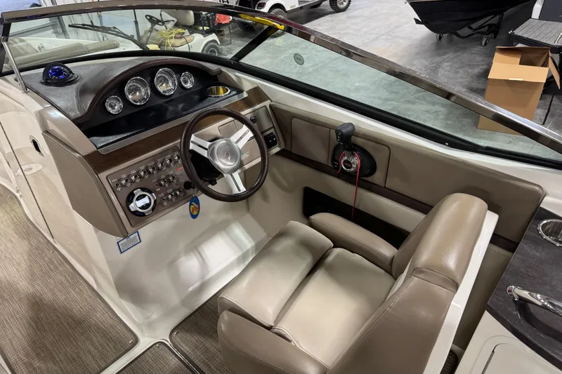 Slide: The Image of 2011 Sea Ray SLX 250 boat interior with steering wheel and control panel. - 7