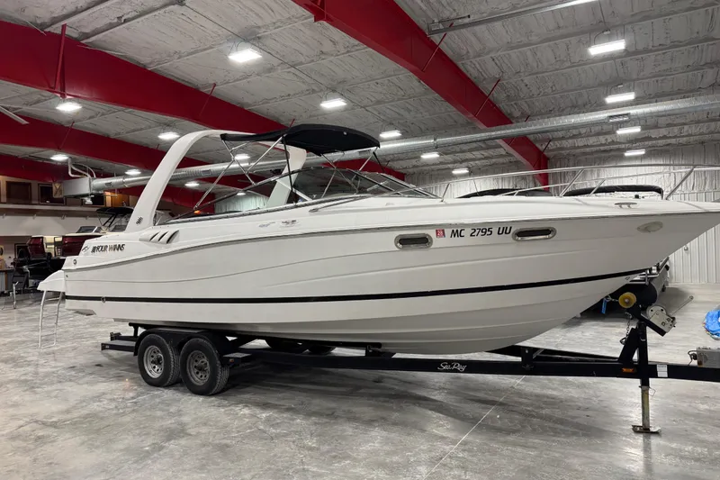 Slide: The Image of 2005 Four Winns 285 Sundowner boat on trailer in indoor storage facility. - 2